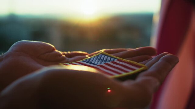 Hands Of An American Soldier Holding An American Flag Patch For Memorial Day