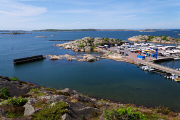 Fototapeta premium Ships harbour at Saltholmen peninsula on the shore of Alvsborgsfjorden, harbour for archipelago ships, Alvsborg district, sunny day, Gothenburg, Sweden