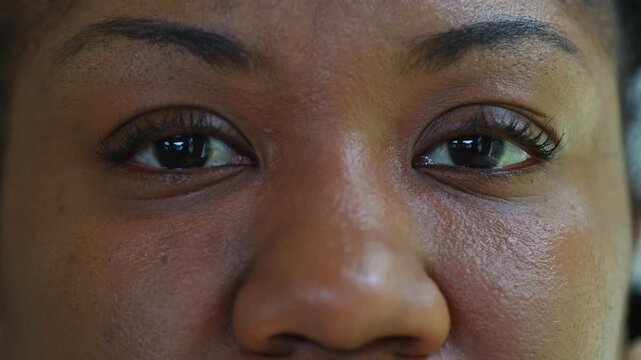 Macro close up of African American woman&rsquo;s eyes, calm and introspective expression conveying strength, femininity, and emotional depth