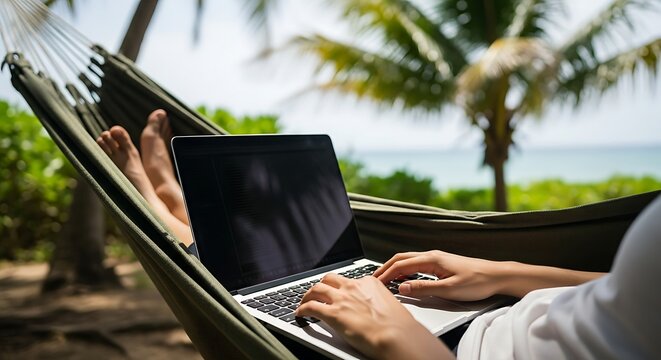 Person Relaxing on Hammock Using Laptop in Tropical Beach Setting