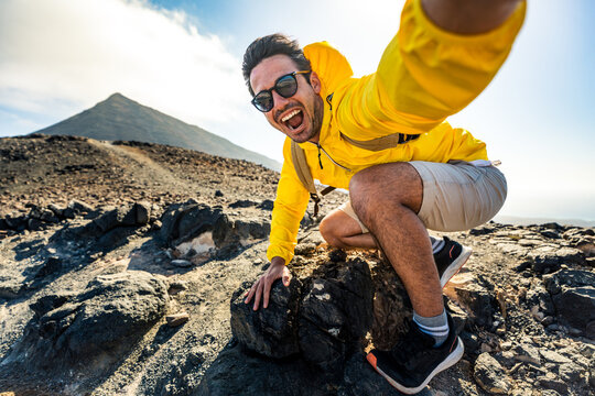 Happy hiker having fun hiking mountains - Active young man taking selfie pic with smart mobile phone device outdoors - Action cam, extreme sports and summertime holidays concept