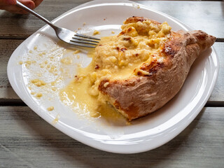 uneaten Adjarian khachapuri at cafe in Batumi city