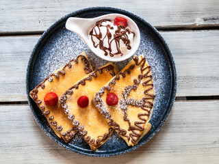 top view of pancakes decorated with chocolate