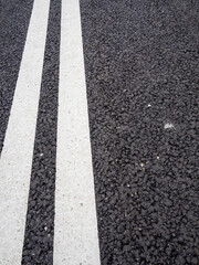 painted double solid lines on new asphalt road