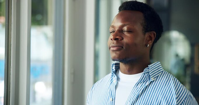 Glasses, black man and deep breath by window for peace, stress relief and fresh air for mindfulness. Calm, positive mindset and programmer with break in creative agency, exhale and relax for wellness