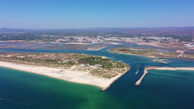 Aerial view drone shot of Tavira Portugal Algarve wide aerial of lagoon mouth and winding channels through ria formosa with turquoise shallows and sandy beaches tour guide viewpoint