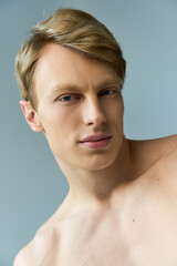 Young alluring man embodies modern masculinity with confidence and charm