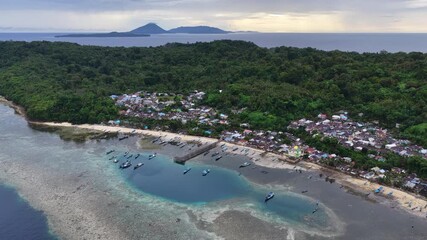 A beautiful coral reef fringes the island of Rhun in the remote Banda Islands of Indonesia. This region is home to spectacular marine biodiversity and is a destination for divers and snorkelers.