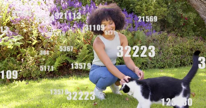 Woman crouching and petting cat in garden reaching causing tech data overlays drifting and growing