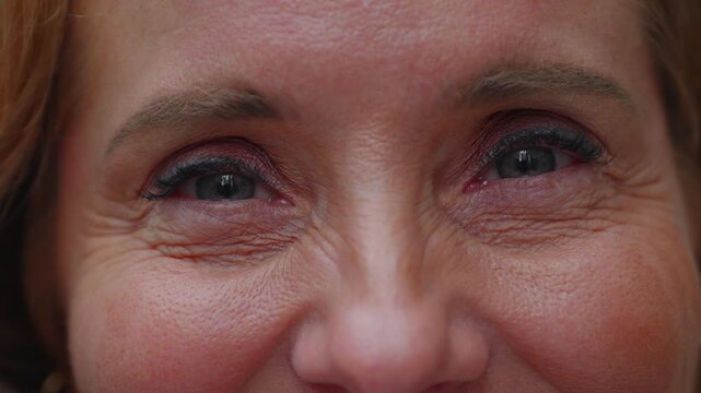 Close-up of smiling middle-aged woman&rsquo;s eyes with visible laugh lines and crow&rsquo;s feet, expressing warmth, joy, and authenticity through genuine happiness