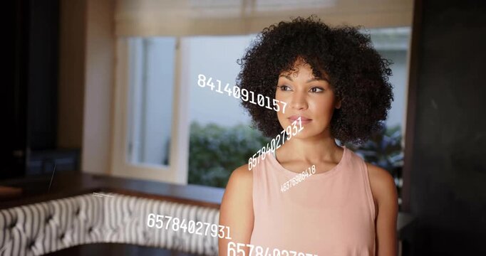Woman standing in lounge with numeric overlays appearing, shifting gaze, smiling, showing tech data