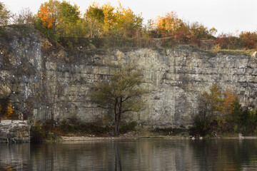 Autumn landscape with yellow trees on the lake shore.