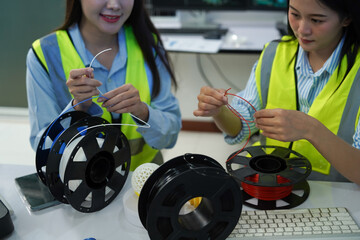 Technicians work with a 3D printer to print a clear white plastic model using cutting-edge technology, focusing on specific points, in a lab.
