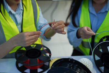 Technicians work with a 3D printer to print a clear white plastic model using cutting-edge technology, focusing on specific points, in a lab.