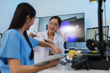 Researchers are working with a 3D printer to print clear, white plastic models using cutting-edge, focused technology in the lab.