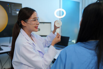 Researchers are working with a 3D printer to print clear, white plastic models using cutting-edge, focused technology in the lab.