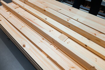 Wooden planks stacked neatly in a workshop ready for carpentry projects during daylight hours