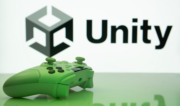 Dhaka, Bangladesh- 14 Nov 2025: A close-up of a white gamepad with the Unity seen on screen in the background.