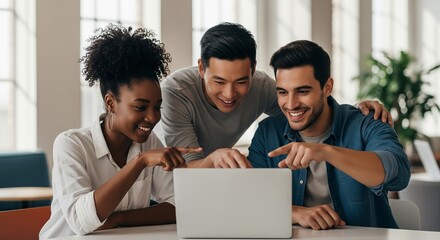 Diverse group of young professionals collaborating on a laptop smiling and pointing at the screen teamwork in a modern office environment