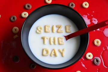 Seize the day spelled out with cereal in milk on red background