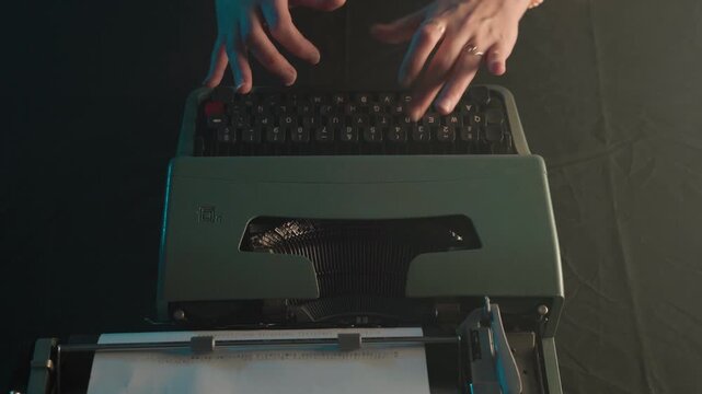 hands seen from above typing on a typewriter