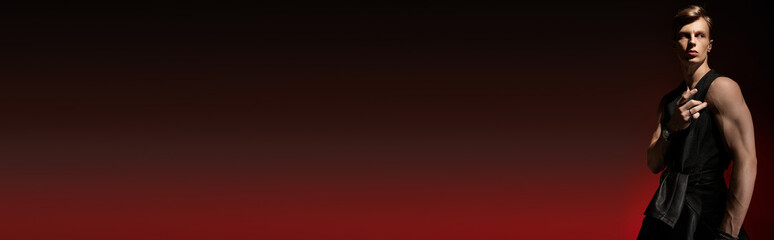 Captivating young man embodies modern masculinity in striking lighting