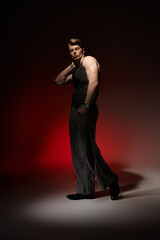 Expressing modern masculinity through confident poses and style in a dramatic setting