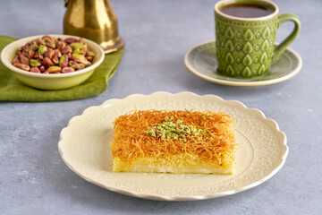 Middle eastern sweets knafeh, kunafa, kadayif with pistachio and syrup . Turkish, arabic traditional dessert