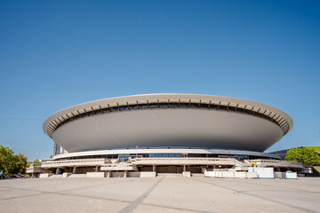 Spodek Arena in Katowice, Poland, on a sunny day with clear blue sky