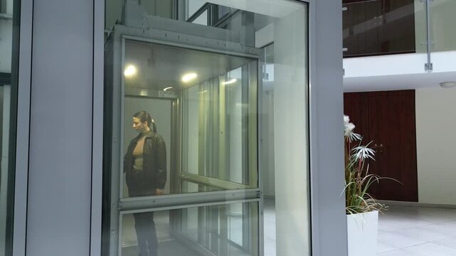 Young girl riding in a modern elevator, showcasing her journey as the camera pans and zooms, capturing the sleek design and ambient lighting throughout the scene
