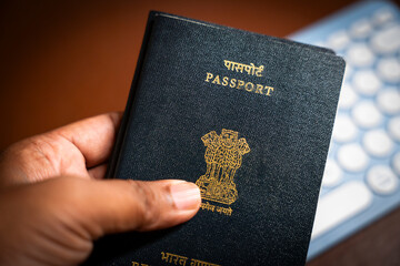 Indian passports placed together on a desk, showing their textured covers and the national emblem...