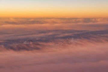 Aerial view of Mt. Ararat and Little Mount Ararat at sunset with colorful clouds and snowy peaks. Turkish name Ağrı Dağı