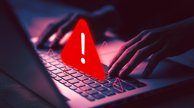 Cybersecurity warning with red alert sign on laptop, symbolizing online threat, hacking danger, virus alert, cyber attack, data protection, and digital security issues.