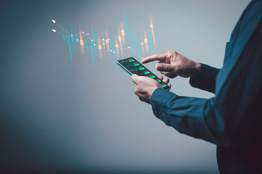 Mobile trading concept showing a person analyzing digital stock charts on a smartphone, highlighting modern finance, real-time investment decisions, and data-driven market strategies.