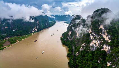 Dense fog over river gorge surrounded by thick forest