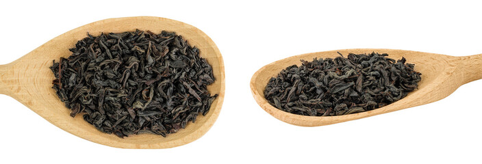 Dry black tea leaves in wooden spoon isolated on white background. Top view. Flat lay