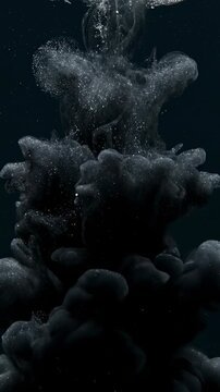 Extreme close-up slow motion shot of thick black cosmic ink slowly diffusing and expanding underwater, creating nebulous, mysterious submersion effects macro, diffusing, chemical