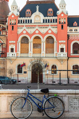 Oradea, Romania - 29 December 2019: Bicycle and Town hall square (Piata Unirii) with a building in Art Nouveau style of the town hall