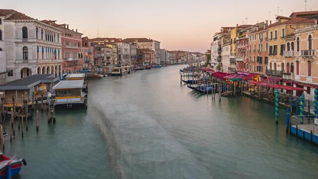 Night to day transition long exposure time lapse Grand Canal traffic view from Rialto Bridge, Venice, Italy