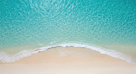 Aerial view of a pristine tropical beach with crystal clear turquoise water gently lapping onto the soft, golden sand, showcasing the serene beauty of a secluded paradise