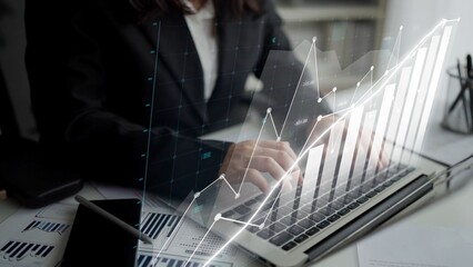 A business professional engages in data analysis on a laptop, showcasing growth trends through a graphical overlay in a modern office setting for financial insights. Copula