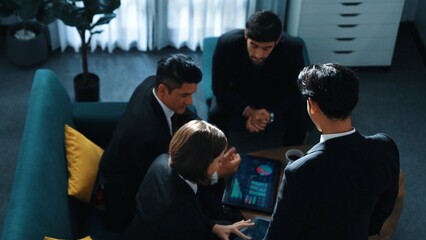 Top view of diverse people walking out of room while marketing team analyze financial graph from tablet at meeting room. Back view of smart team present data analysis chart to investors. Directorate.
