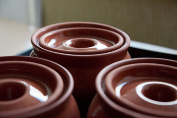 Close-up of upturned clay baking pot lids. Close-up of empty clay pots.