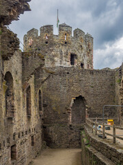 A view of an ancient stone tower seen from within the ruins of a medieval castle (Conwy, Wales, United Kingdom)
