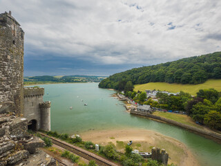A high angle scenic view from a historic castle over a wide river, coastline, and countryside (Conwy, Wales, United Kingdom)