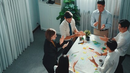 Top view of professional business team working together to brainstorm environmental idea by using...