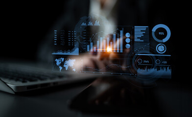 A businessman reviews digital data analytics with interactive graphs and charts in a professional workspace environment, emphasizing modern technology and insights. Scalp