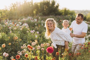 Family enjoying piggyback ride in dahlia garden