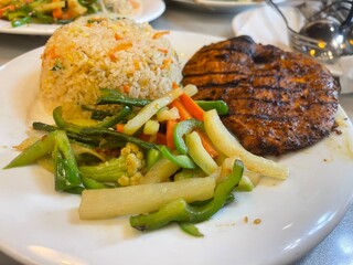 Delicious Grilled Chicken with Fried Rice and Mixed Vegetables. pork chop with vegetables.