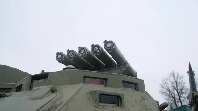 roof-mounted Russian rocket tubes on turret, green armored vehicle with angled launch rails, close-up low-angle